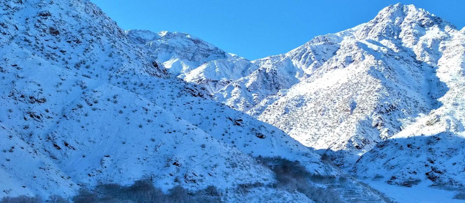 Snow-capped High Atlas peaks above the trekking terrain near Imlil