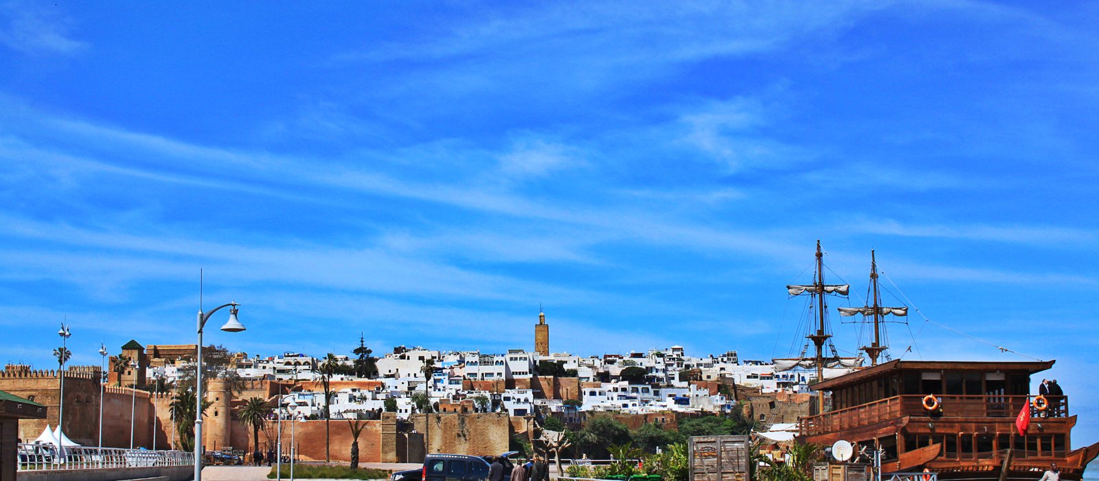 Wide view of the whitewashed Kasbah des Oudayas overlooking the Bou Regreg river and the Atlantic coast in Rabat, Morocco